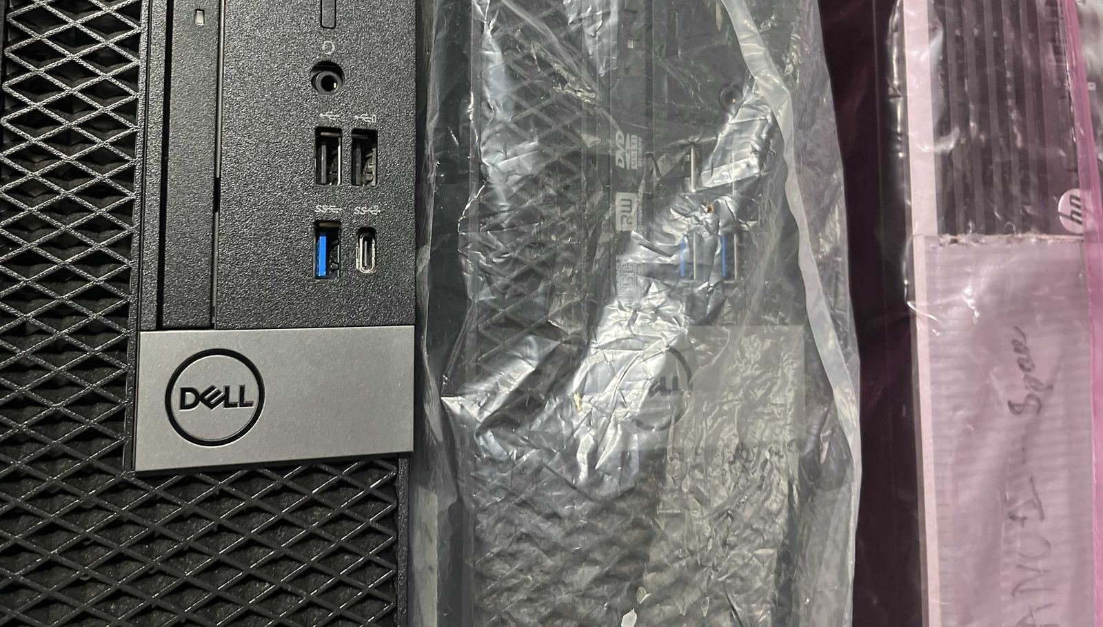 Decommissioned desktop computers wrapped and ready for recycling or data destruction.