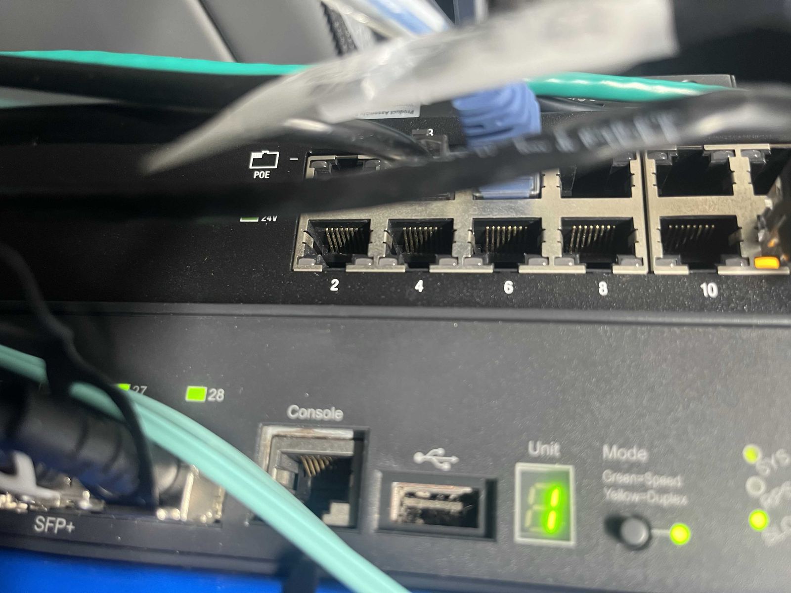 A small business network switch with PoE cabling, the kind of setup behind reliable office Wi-Fi.