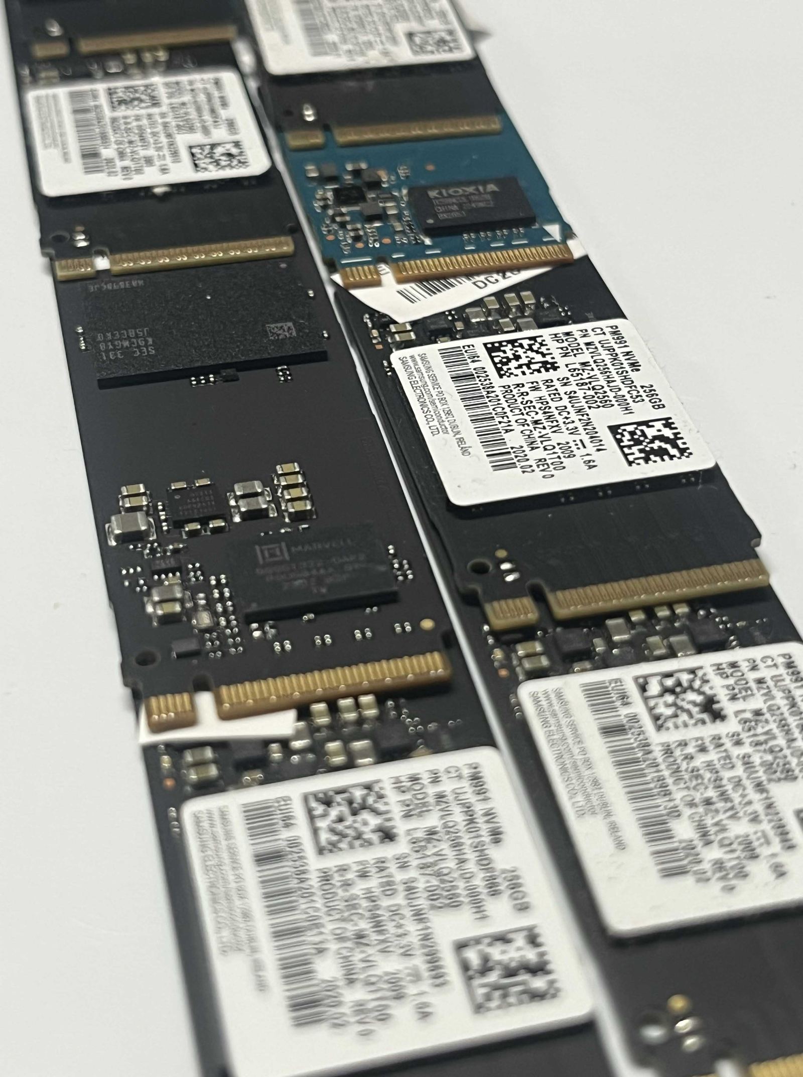 Close-up of NVMe M.2 solid-state drives lined up on a workbench during an upgrade job.